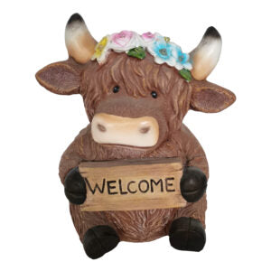 highland cow with welcome statue