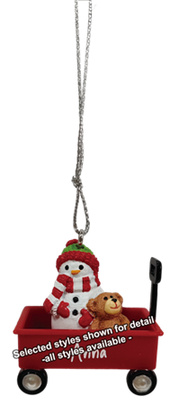 A Christmas ornament featuring a red wagon with a snowman wearing a green and red hat, a small brown teddy bear, and a silver hanging chain, shown on a white background with a text overlay.